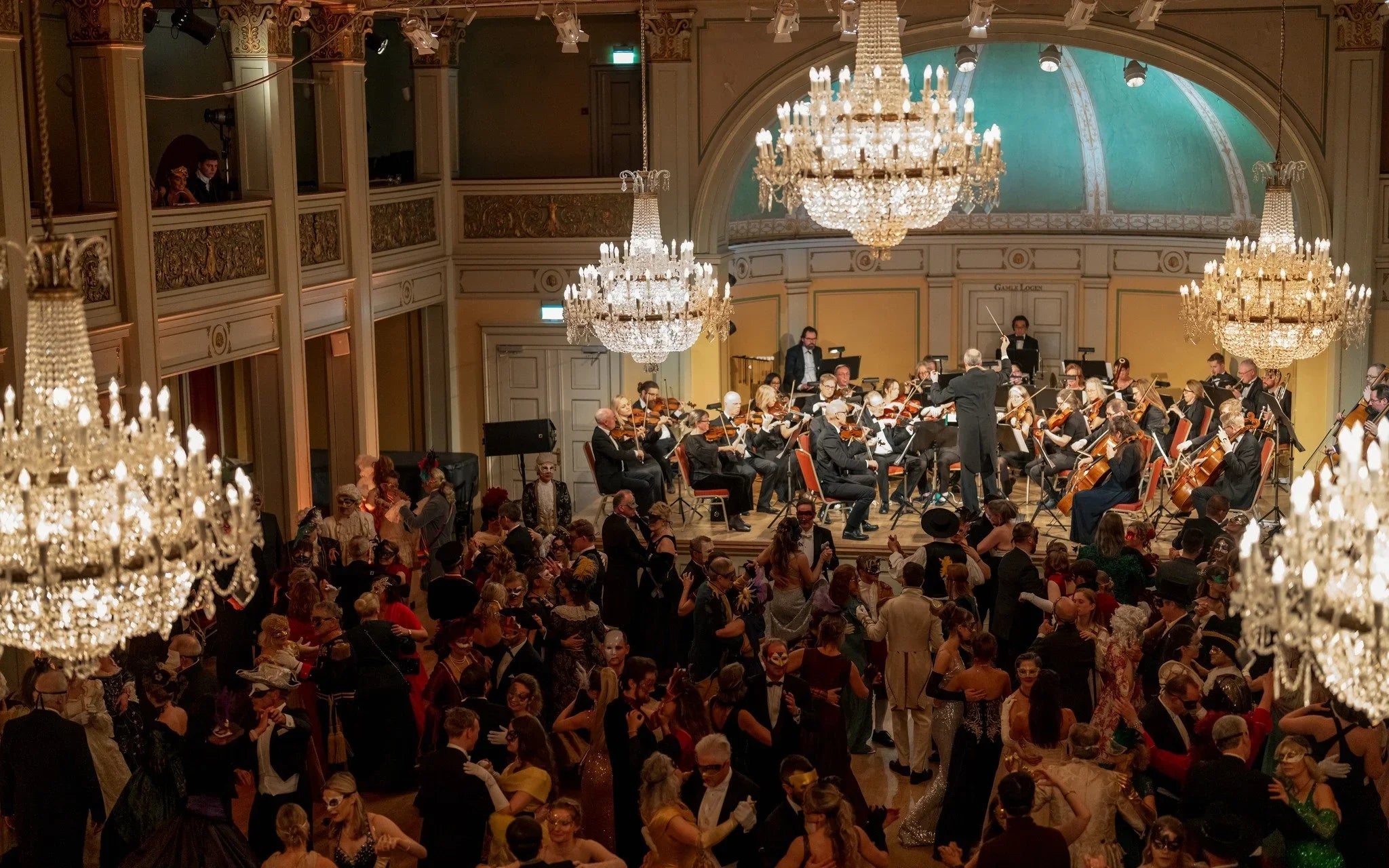 Oslo Operaball masquerade at Gamle Logen with orchestra and masked dancers in elegant hall